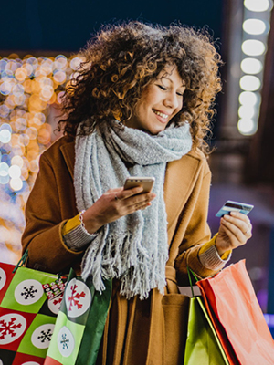 A lady looking at her card while shopping. 