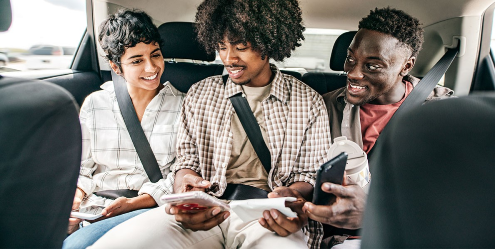 3 people riding in a car