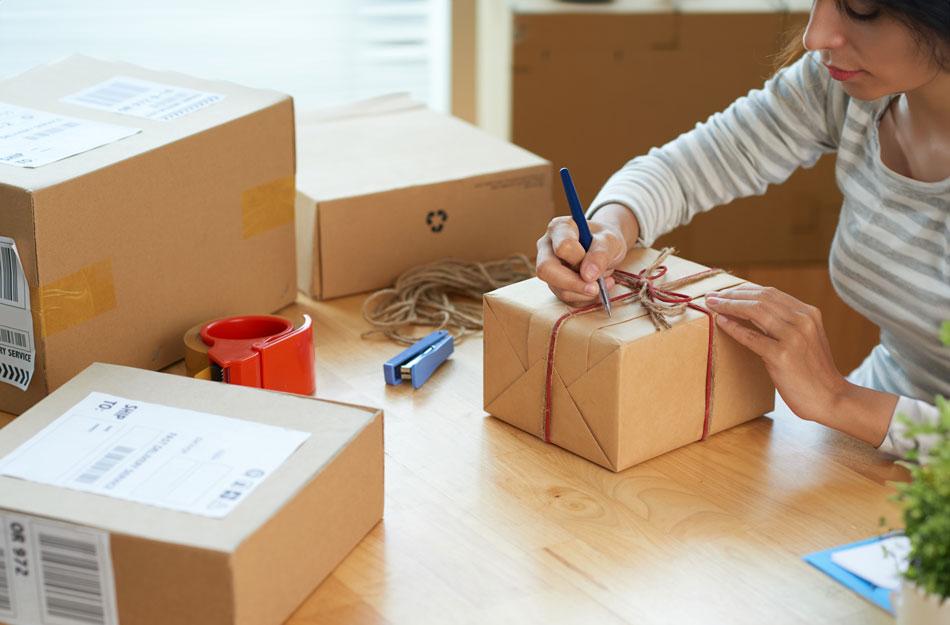 someone labeling a package to be shipped