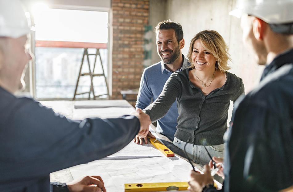 4 people working on house plans