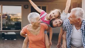 grandparents laughing with their grandkids