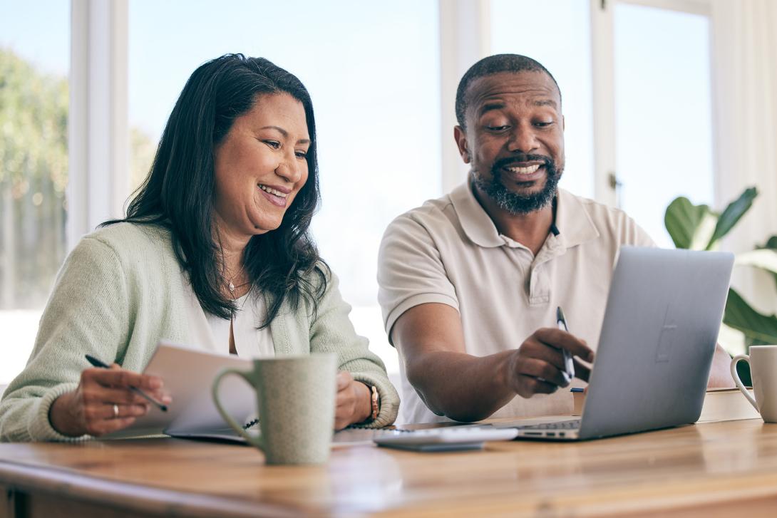 man and woman looking at the computer